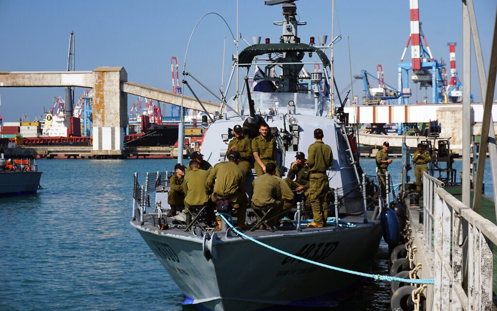 Israeli Navy troops relax on the deck of a Dvora-class patrol boat docked at Ashdod Base, at the Ashdod port in southern Israel, March 27, 2023. (Emanuel Fabian/Times of Israel)