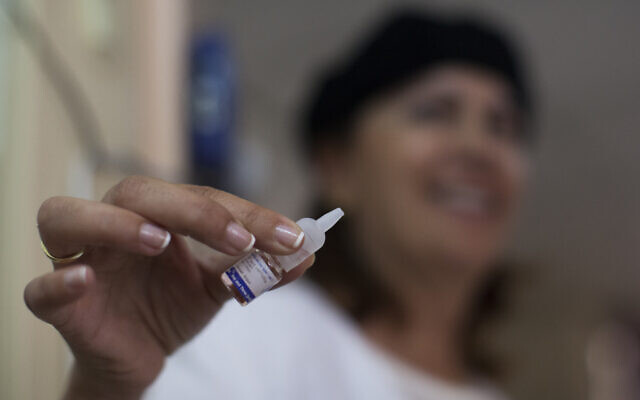 A file photo from 2013 shows a worker holding a polio vaccine at a medical center in Jerusalem. (Yonatan Sindel/Flash90)