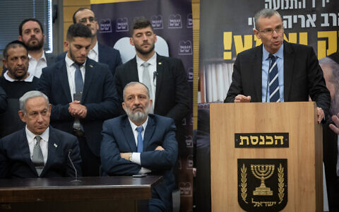 Justice Minister Yariv Levin (R) speaks during a Shas faction meeting at the Knesset on January 23, 2023. Sitting next to him are Shas chief Aryeh Deri and Prime Minister Benjamin Netanyahu. (Yonatan Sindel/Flash90)