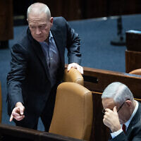 Defense Minister Yoav Gallant (left) seen with Prime Minister Benjamin Netanyahu and Justice Minister Yariv Levin in the Knesset on February 15, 2023. (Yonatan Sindel/Flash90)