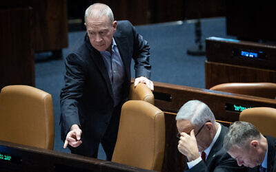 Defense Minister Yoav Gallant (left) seen with Prime Minister Benjamin Netanyahu and Justice Minister Yariv Levin in the Knesset on February 15, 2023. (Yonatan Sindel/Flash90)