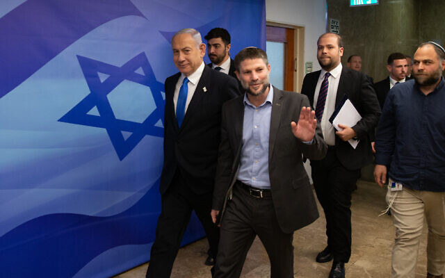 Prime Minister Benjamin Netanyahu (L) and Finance Minister Bezalel Smotrich arrive at a cabinet meeting at the Prime Minister's Office in Jerusalem on February 23, 2023. (Alex Kolomoisky/Pool)