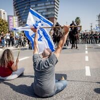 Demonstrators block a road and clash with police as they protest against the government's planned judicial overhaul, in Tel Aviv, March 1, 2023. (Erik Marmor/Flash90)