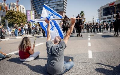 Demonstrators block a road and clash with police as they protest against the government's planned judicial overhaul, in Tel Aviv, March 1, 2023. (Erik Marmor/Flash90)