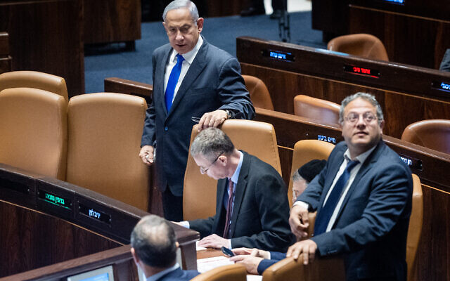 Prime Minister Benjamin Netanyahu (L) with Justice Minister Yariv Levin (C) and Natioanl Security Minister Itamar Ben Gvir (R)  during a discussion and a vote in the the Knesset on March 1, 2023. (Yonatan Sindel/Flash90)
