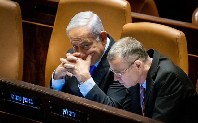 Prime Minister Benjamin Netanyahu with Justice Minister Yariv Levin during a debate and a vote in the  Knesset plenum, March 6, 2023. (Yonatan Sindel/Flash90)