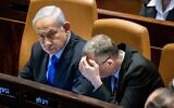 Prime Minister Benjamin Netanyahu (left) and Justice Minister Yariv Levin in the Knesset plenum in Jerusalem on March 6, 2023. (Yonatan Sindel/Flash90)