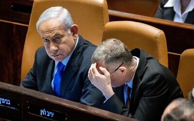 Prime Minister Benjamin Netanyahu (left) and Justice Minister Yariv Levin in the Knesset in Jerusalem on March 6, 2023. (Yonatan Sindel/Flash90)