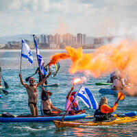 Israelis on boats protest the government's planned judicial overhaul, at the sea in Haifa, northern Israel, March 9, 2023 (Shir Torem/Flash90)