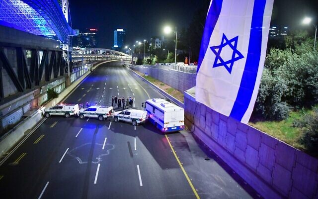 Police are seen on the Ayalon Highway during a demonstration against the government's planned judicial overhaul, in Tel Aviv, on March 11, 2023. (Erik Marmor/Flash90)