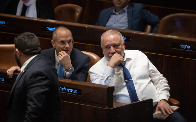 MK Avigdor Liberman, right, seen at the assembly hall of the Knesset in Jerusalem, on March 13, 2023. (Yonatan Sindel/Flash90)