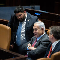 Prime Minister Benjamin Netanyahu (C) with Foreign Minister Eli Cohen (R) and MK Almog Cohen in the Knesset on March 13, 2023. (Yonatan Sindel/Flash90)