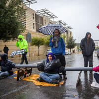 Protesters against the judicial overhaul block a road near the government complex in Jerusalem, March 14, 2023 (Yonatan Sindel/Flash90)