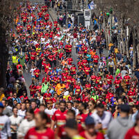 Thousands of runners take part in the 12th annual Jerusalem Marathon on Jaffa Street, March 17, 2023. (Yonatan Sindel/Flash90)