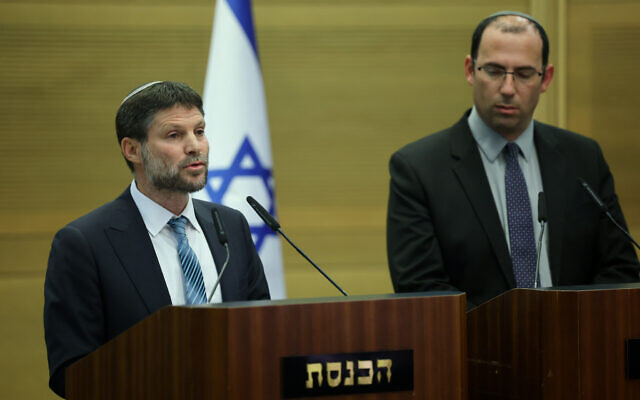 Finance Minister Bezalel Smotrich, left, speaks at a press conference in the Knesset in Jerusalem on March 21, 2023, alongside Constitution Committee head Simcha Rothman. (Yonatan Sindel/Flash90)
