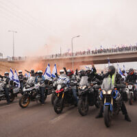 A convoy of motorcycles with Israeli flags as part of a protest against the planned judicial overhaul, in Herzliya, on March 23, 2023. (Yossi Aloni/Flash90)