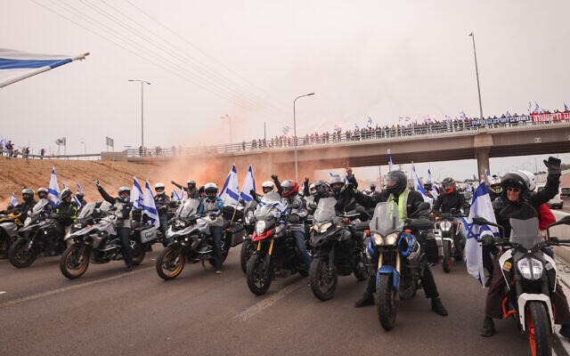 A convoy of motorcycles with Israeli flags as part of a protest against the planned judicial overhaul, in Herzliya, on March 23, 2023. (Yossi Aloni/Flash90)