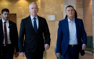 Minister of Defense Yoav Gallant (left) and MK Yuli Edelstein arrive for a meeting of the Defense and Foreign Affairs Committee, in the Knesset on March 27, 2023. (Yonatan Sindel/Flash90 )