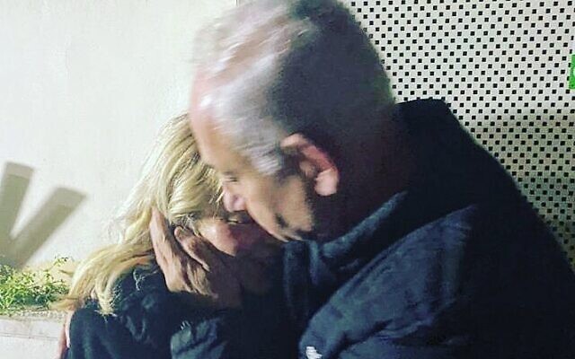 Prime Minister Benjamin Netanyahu embraces his wife Sara, in a photo he tweeted out late March 2, 2023 after she was extricated from a hair salon as demonstrators gathered outside. (Via Twitter)