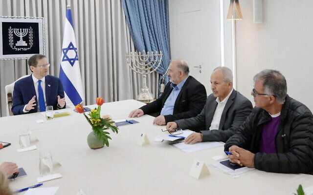 In this handout photo, President Isaac Herzog, left, meets with representatives of the Ra'am party at the President's Residence in Jerusalem, March 29, 2023. (Amos Ben Gershom/GPO)