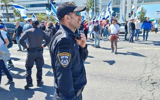 Police watch a protest in Haifa on March 16, 2023 (Israel Police)
