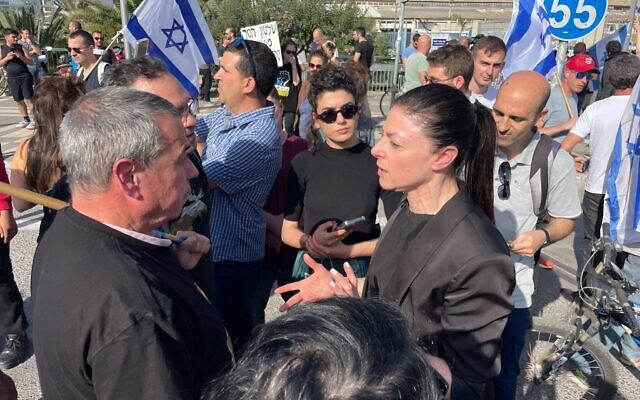Labor party leader Merav Michael (R) joins protests in Tel Aviv on March 1, 2023 (Carrie Keller-Lynn/Times of Israel)