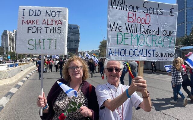 Julie Gray, L, and her husband Gidon Lev take part in protests in Tel Aviv on March 16, 2023 (Carrie Keller-Lynn/Times of Israel)