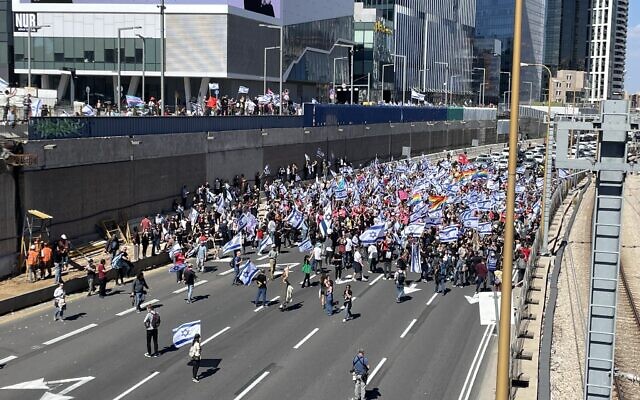 Demonstrators block the Ayalon Highway in Tel Aviv on March 16, 2023 (Carrie Keller-Lynn/Times of Israel)