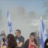 A smoke grenade is thrown toward protesters demonstrating against National Security Minister Itamar Ben Gvir in Kfar Uriah, March 18, 2023. (Screen grab; used in accordance with Clause 27a of the Copyright Law)