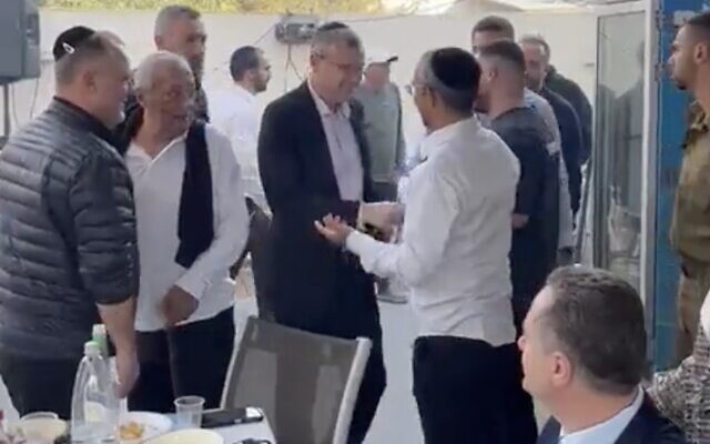 In a screenshot from video, Justice Minister Yariv Levin (center in black jacket) is seen greeting Rafi Kedoshim during a Purim party at the latter's home in Herzliya. In the foreground on the right is Energy Minister Israel Katz. (Twitter screenshot; used in accordance with Clause 27a of the Copyright Law)
