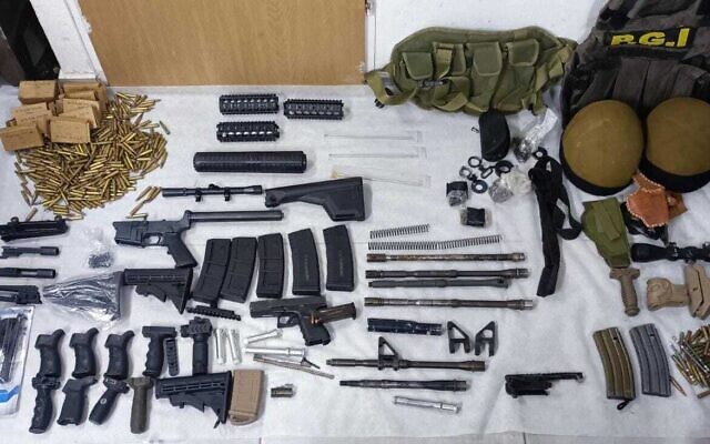 A handgun and weapon parts seized in the West Bank city of Hebron, March 13, 2023. (Israel Police)