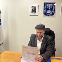 Finance Minister Bezalel Smotrich signs a directive canceling a special tax on sugary drinks, March 28, 2023. (Finance Ministry)