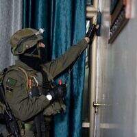 An Israeli soldier takes mesasurements at the home of Abdel Fattah Hussein Kharousha, a Hamas member accused of carrying out a deadly attack in Huwara, in the West Bank city of Nablus early March 22, 2023. (Israel Defense Forces)