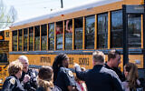 School buses with children arrive at Woodmont Baptist Church to be reunited with their families after a mass shooting at The Covenant School in Nashville, Tennessee, on March 27, 2023. (Getty Images via AFP)