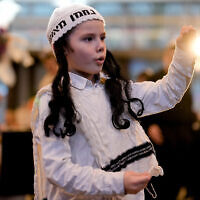 A boy dances to celebrate Purim at a party in a hotel in Berlin, Germany, March 7, 2023. (AP/Markus Schreiber)
