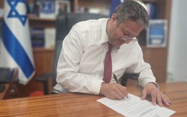 National Security Minister Itamar Ben Gvir signs an order to shutter the Jerusalem office of the Voice of Palestine radio station on March 20, 2023. (National Security Ministry)