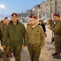 Lt. Nadav Weinberg (center), wounded in a Janurary shooting attack in Jerusalem walks at the Western Wall during a military ceremony, early March 8, 2023. (Courtesy of The Western Wall)