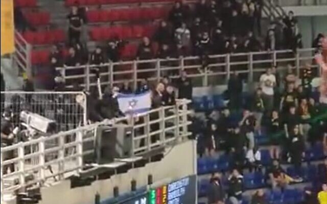 Fans of AEK Athens burn an Israeli flag at a match against Hapoel Jerusalem, in Athens, Greece, April 12, 2023. (Twitter video screenshot: used in accordance with Clause 27a of the Copyright Law)