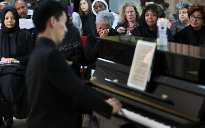 A man plays a piano belonging to late Ethiopian nun and pianist Emahoy Tsegue-Maryam Guebrou, during her funeral on March 31, 2023, at the Kidane Mehret Ethiopian Orthodox Church in Jerusalem. (AHMAD GHARABLI / AFP)