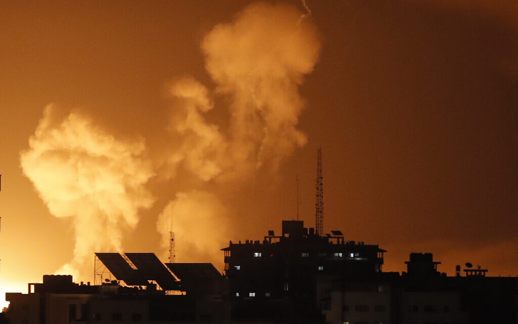 Smoke rises above buildings in Gaza City as Israel launches air strikes on the Hamas-run Palestinian enclave on late April 6, 2023. (Mohammed Abed/AFP)
