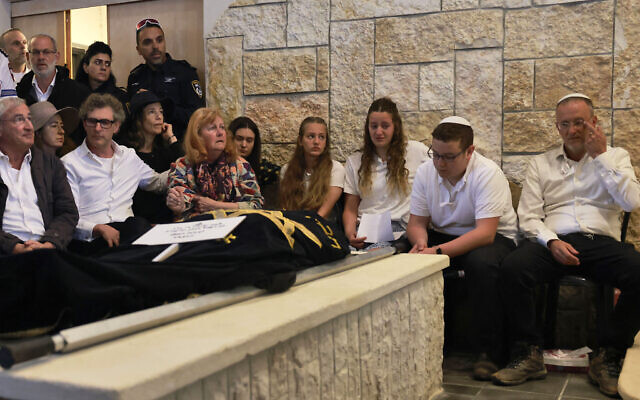 Mourners including the husband and children of Lucy Dee, 48, who was killed in a West Bank terror shooting attack, attend her funeral at the Gush Etzion Regional Cemetery in Kfar Etzion on April 11, 2023. (Photo by Menahem KAHANA / AFP)