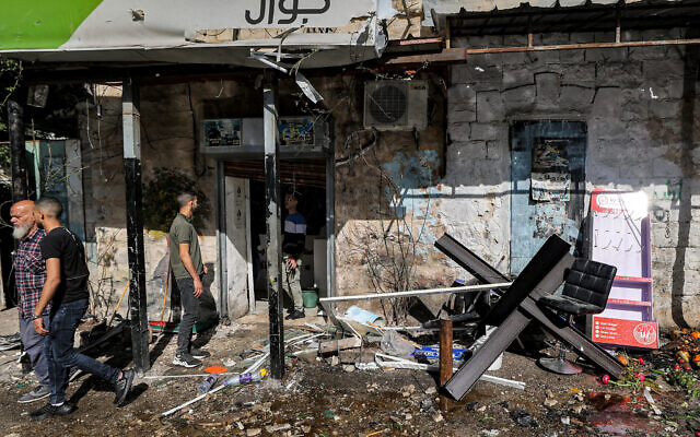 FILE: People gather outside a ransacked building following an Israeli military raid in the Jenin refugee camp in the West Bank on April 18, 2023. (JAAFAR ASHTIYEH / AFP)