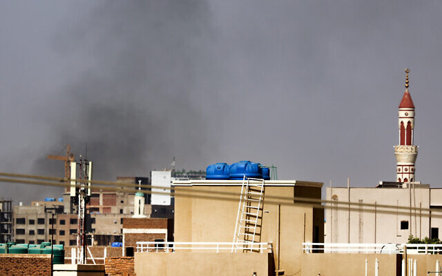 Smoke billows over residential buildings in eastern Khartoum on April 22, 2023, during ongoing battles between the forces of two rival generals. (AFP)