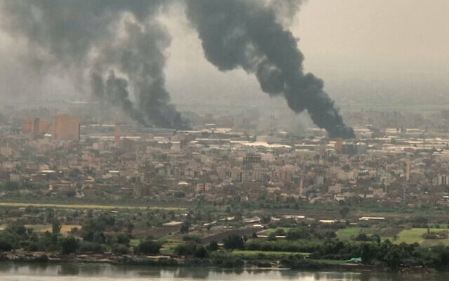 This image grab taken from AFPTV video footage on April 28, 2023, shows an aerial view of black smoke rising over Khartoum. (AFPTV/AFP)