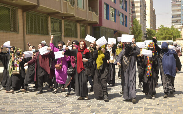 Afghan women hold placards as they march to protest for their rights, in Kabul, Afghanistan, on April 29, 2023. (AFP)