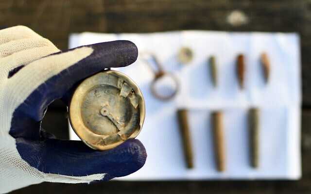 A compass and other items from a 1948 War of Independence battle that have been found on Ha-Lamed Heh Battle Hill, April 2023. (Yoli Schwartz/Israel Antiquities Authority)