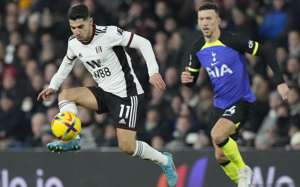 Fulham's Manor Solomon, left, is in action during the English Premier League soccer match between Fulham and Tottenham Hotspur at the Craven Cottage Stadium in London, Monday, January 23, 2023. (AP Photo/Frank Augstein)