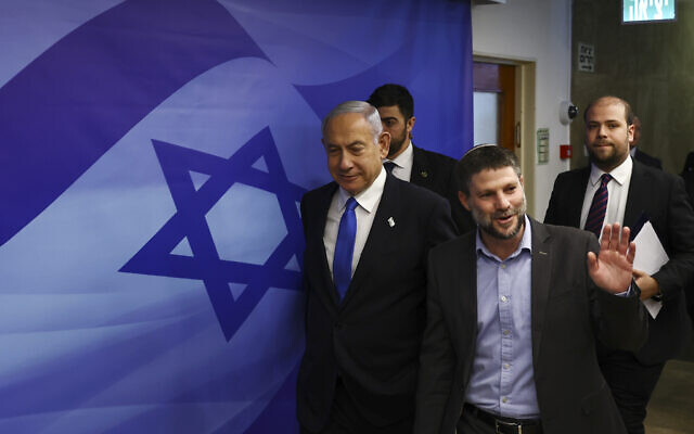 Prime Minister Benjamin Netanyahu, left, and Finance Minister Bezalel Smotrich, right, arrive to attend a cabinet meeting at the Prime Minister's office in Jerusalem, Feb. 23, 2023. (Ronen Zvulun/Pool Photo via AP)