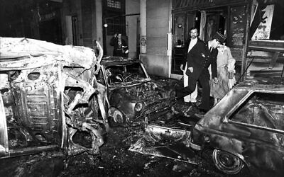 A police officer walks at the scene after the bombing of the Copernic street synagogue, in Paris, that killed 4 people on October 3, 1980. (Remy de la Mauviniere/AP)