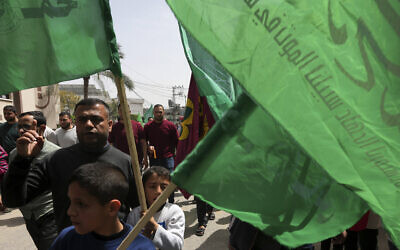 Illustrative image: Hamas supporters wave green Islamic flags during a protest to show the solidarity with Al-Aqsa Mosque, in Jebaliya City, northern Gaza Strip, April 7, 2023. (AP Photo/Adel Hana)